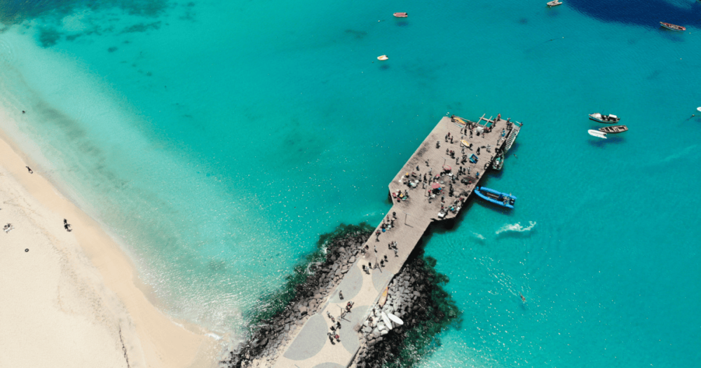 The pier at Cape Verde aerial view at Santa Maria beach in Sal Island Cape Verde - Cabo Verde. Everything Travel - Forever Living Yes.