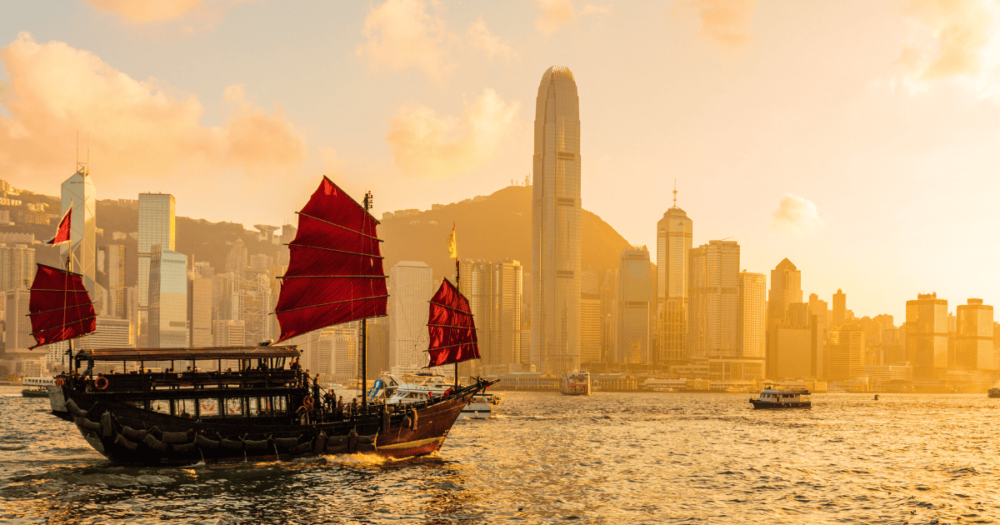 Chinese wooden red sails ship in Hong Kong Victoria Harbour at sunset time. Everything travel.