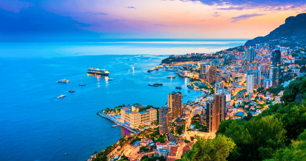 View of the city of Monaco on French Riviera after sunset. 5 cities to visit in Europe 2024. Everything travel. Forever Living Yes.