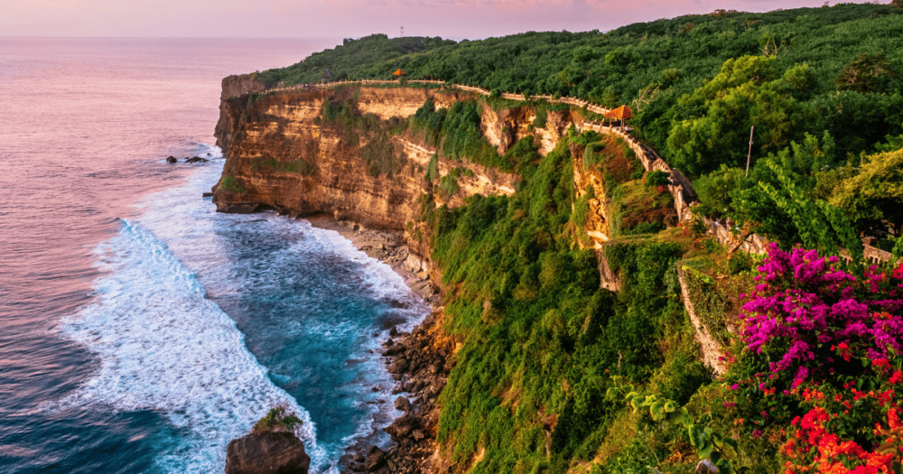 Scenic landscape of high cliff with fantastic sunset sky at Uluwatu cliff. Bali, indonesia. Things to do and places to stay.